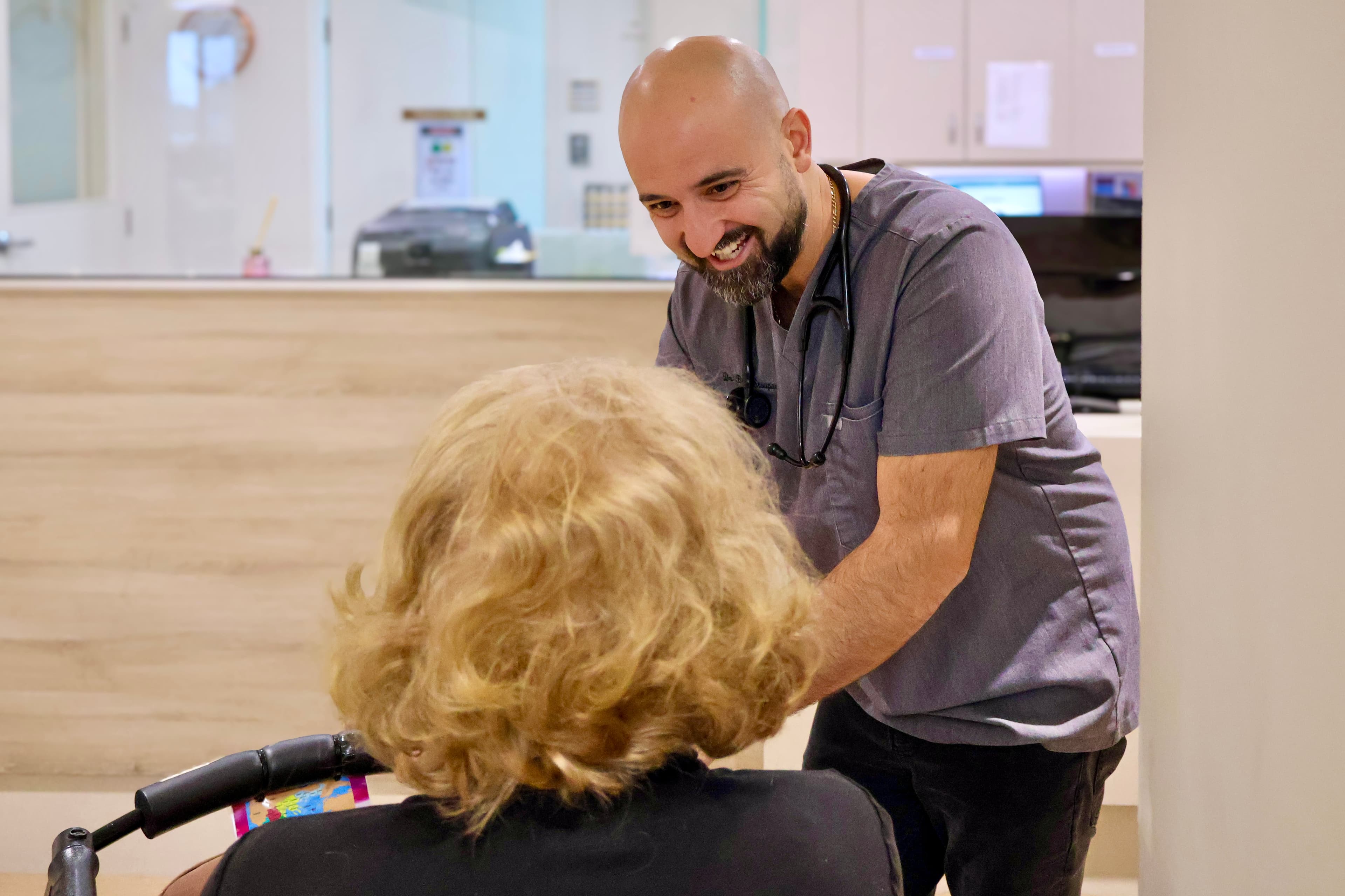 Dr Billy Stoupas engaging with a patient